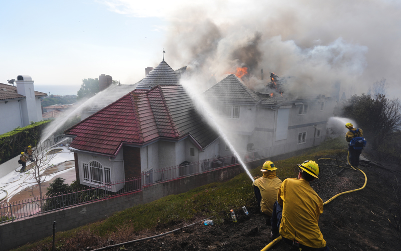 Coastal homes burn as hot winds fuel California fires