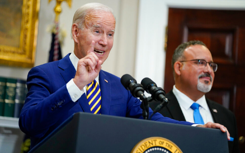 After telling car story, Biden wipes away $300 billion in student loans