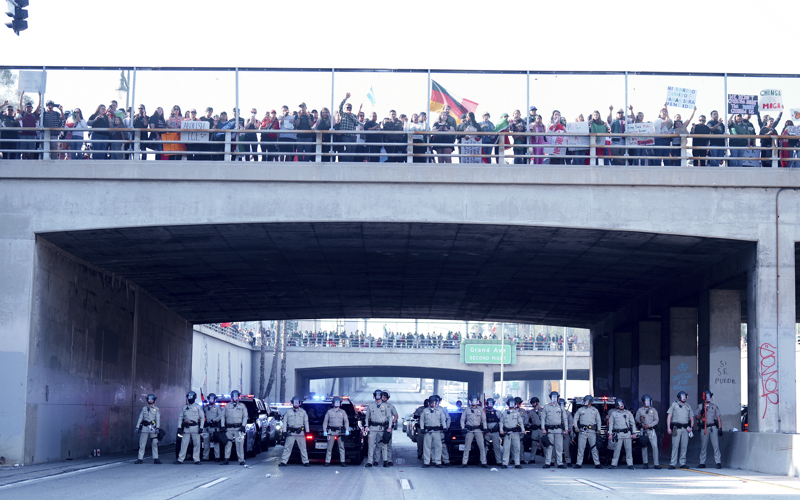 Marchers protesting planned deportations block major freeway in Los Angeles